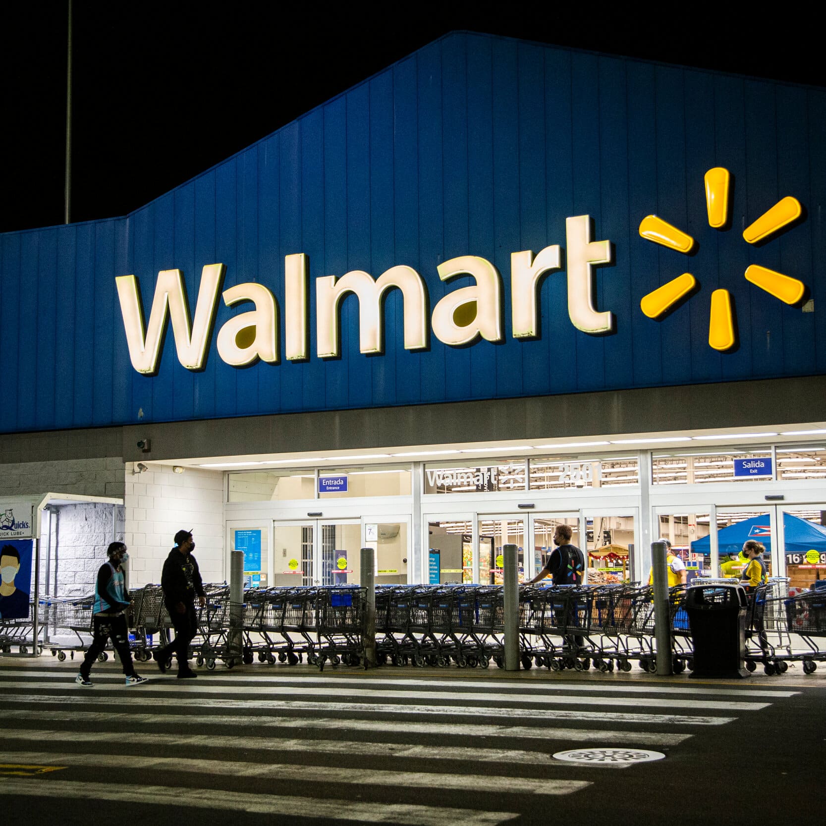 Walmart lowers its profit prediction and blames it on food and gasoline costs.